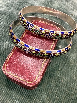 Lot 108 - A pair of vintage silver bangles with enamel...