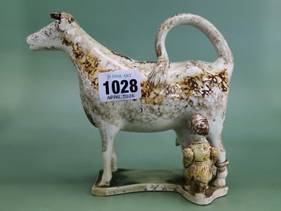 Lot 1028 - A Whieldon type cow creamer, the ochre dappled...