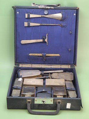 Lot 1043 - A cased dressing table suite silver mounted by...