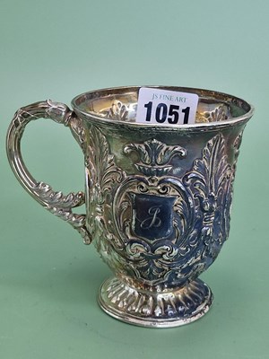 Lot 1051 - A foliate embossed silver christening mug by...