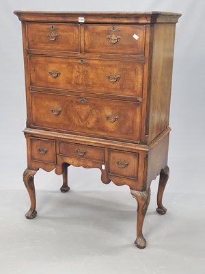 Lot 1066 - A walnut chest on stand, the top with two...