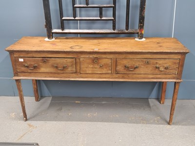 Lot 1074 - A 19th century pine three drawer dresser on...