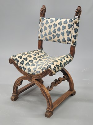 Lot 1076 - A walnut Savonarola style chair, the back...