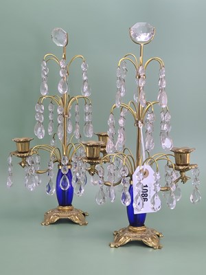 Lot 1086 - A pair of three tier lustre candelabra, the...