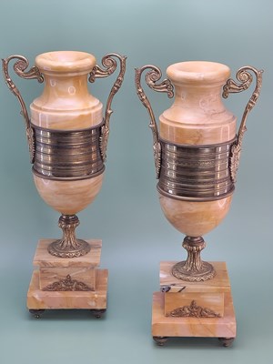 Lot 1310 - A pair of ochre marble urns mounted with...