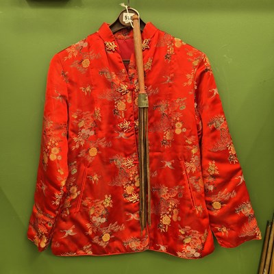 Lot 518 - A Chinese red silk jacket together with a whip...