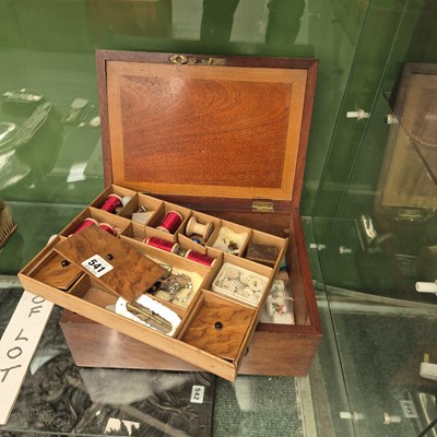 Lot 541 - A mahogany sewing box containing reels,...