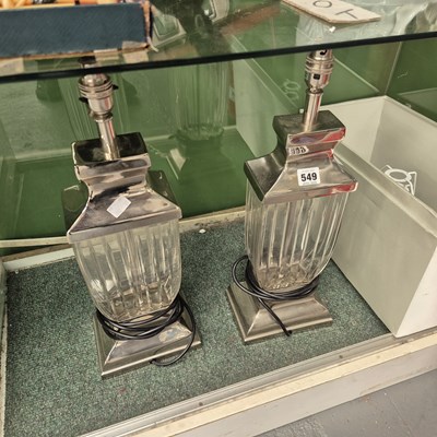 Lot 549 - A pair of chrome and glass table lamps and shades