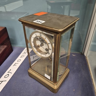 Lot 554 - A glazed brass cased mantle clock with an open...