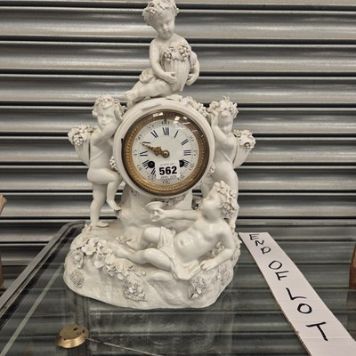 Lot 562 - A striking mantle clock within a German white...