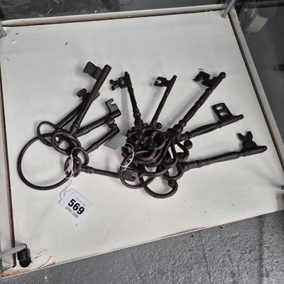 Lot 569 - A collection of nine vintage style iron keys