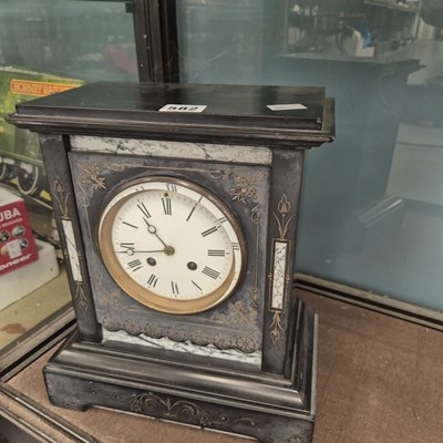 Lot 582 - A black slate cased striking mantle clock