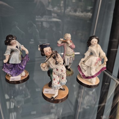 Lot 599 - Four German porcelain figures of musicians and...