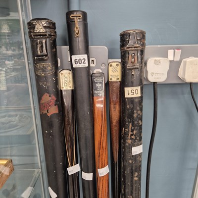 Lot 602 - Three billiard cues with their metal cases by...