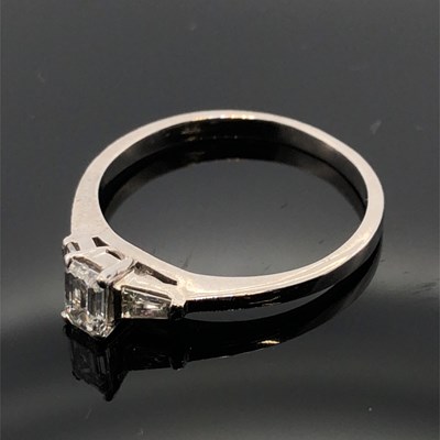 Lot 1104 - A hallmarked platinum and diamond ring. The...