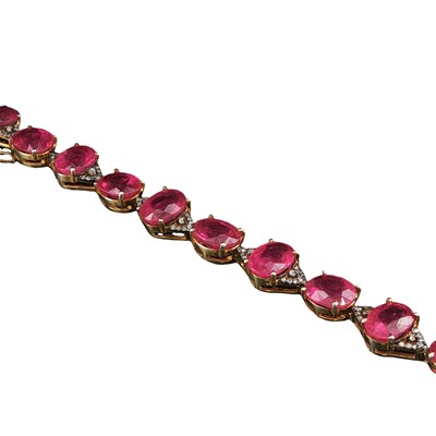Lot 1120 - A silver gilt bracelet set with oval rubies...