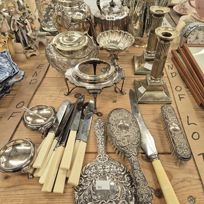 Lot 670 - A silver backed hand mirror with two brushes,...