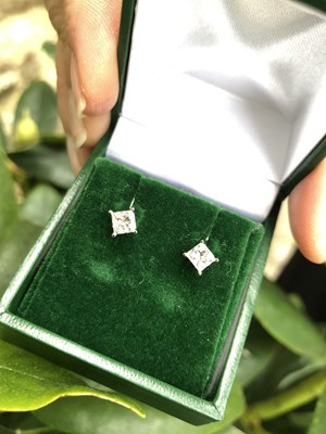 Lot 1113 - Certificated pair of 14ct white gold four-claw...