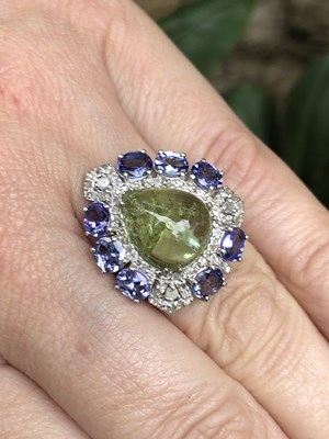 Lot 1152 - Silver dress ring set with a naturally flawed...