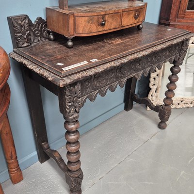 Lot 72 - An antique carved oak hall table H 76 W 104 D...