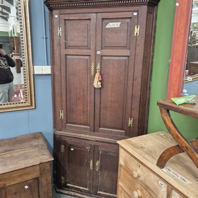 Lot 144 - A large Georgian oak floor-standing corner...