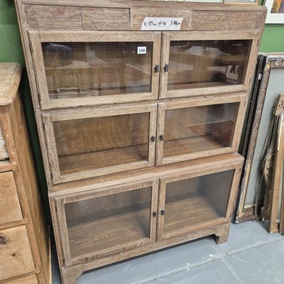 Lot 149 - A limed oak glazed three section bookcase H...