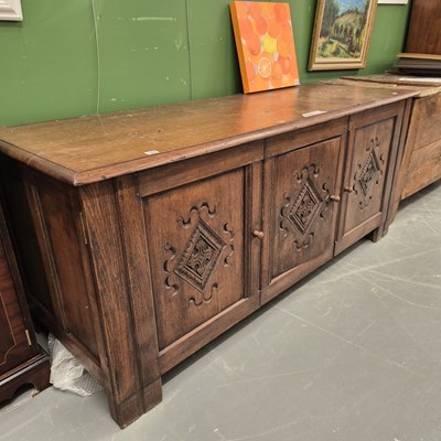 Lot 188 - An antique oak low side cabinet with three...