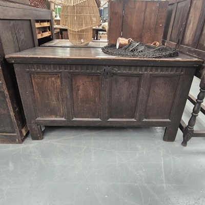 Lot 207 - An 18th century oak coffer with a four-panel...