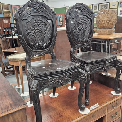 Lot 218 - A pair of oriental hardwood hall chairs