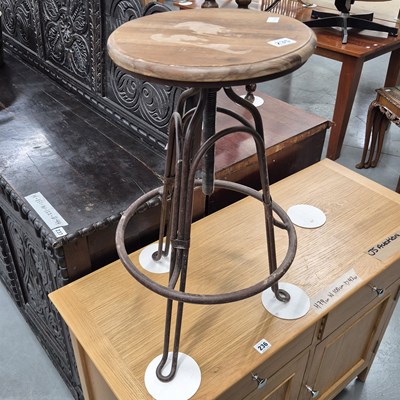 Lot 235 - An industrial style iron stool with wooden seat