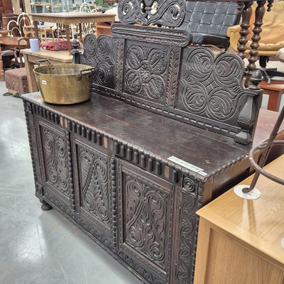 Lot 237 - A large carved oak side cabinet with a raised...