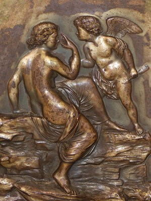 Lot 1315 - A silvered metal relief plaque depicting Cupid...