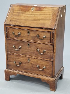 Lot 1326 - A mahogany bureau, the fall above three graded...