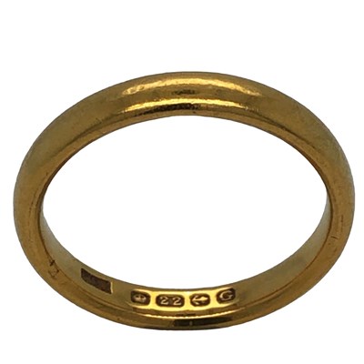 Lot 1110 - A 22ct hallmarked gold wedding ring, size M½,...
