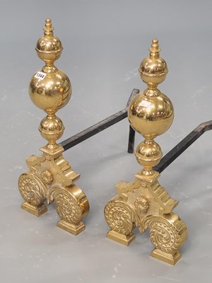 Lot 1344 - A pair of brass fire dogs, the ball and spire...