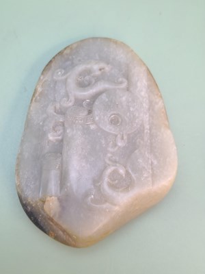 Lot 1351 - A Chinese nephrite jade pebble carved in...