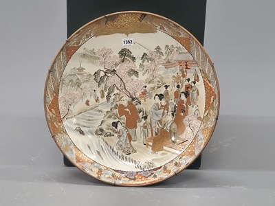 Lot 1352 - A Japanese Kutani dish painted with figures...