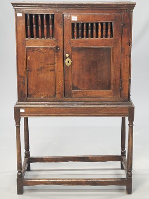 Lot 1363 - A 17th century oak food cupboard on stand with...