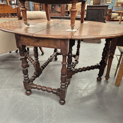 Lot 258 - A large 18th century country oak gateleg table...