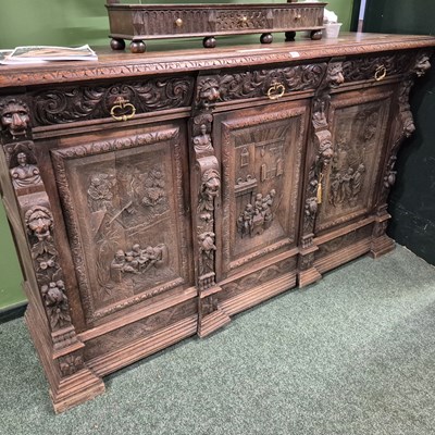 Lot 411 - A large carved oak three-door side cabinet H...