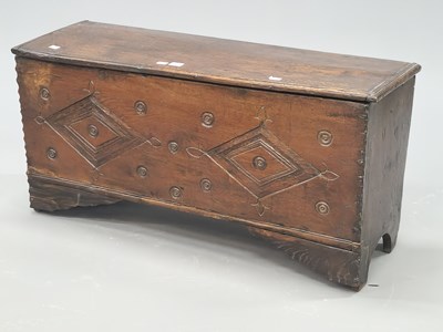 Lot 1373 - An 18th century oak coffer the plank front...