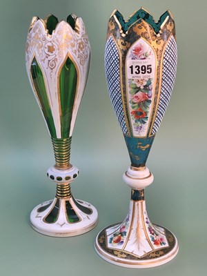 Lot 1395 - Two Bohemian white overlay green glass vases...