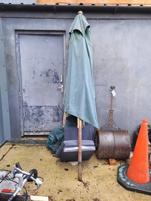Lot 444 - A large teak garden parasol with spare parasol...
