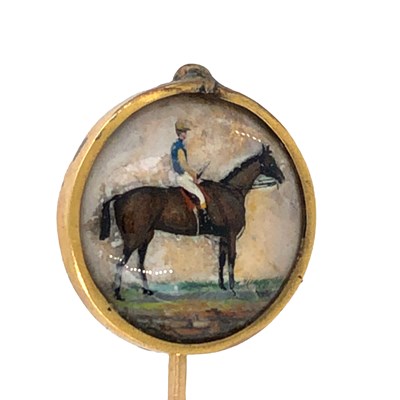 Lot 1153 - An antique adapted stick pin featuring a rider...