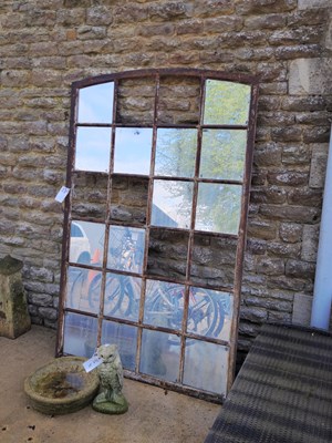 Lot 472 - A cast iron window frame with mirrored panes...