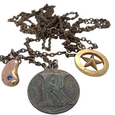 Lot 1156 - A rose gold and gem-set coffee bean charm...