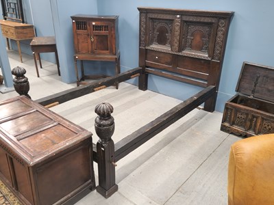 Lot 1430 - An 18th century oak double bed, the head board...