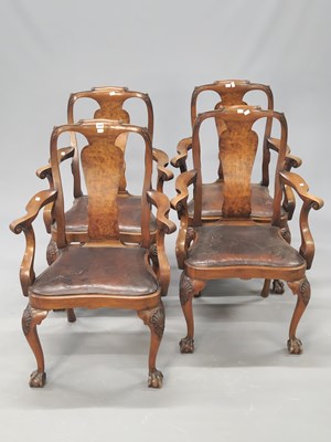 Lot 1440 - A set of four walnut elbow chairs with drop in...