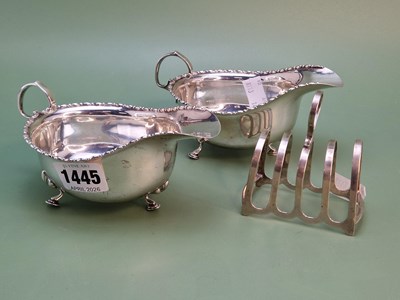 Lot 1445 - A pair of silver tripod sauce boats,...