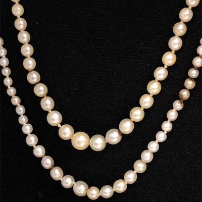 Lot 1198 - Two strands of cultured pearls, each with...
